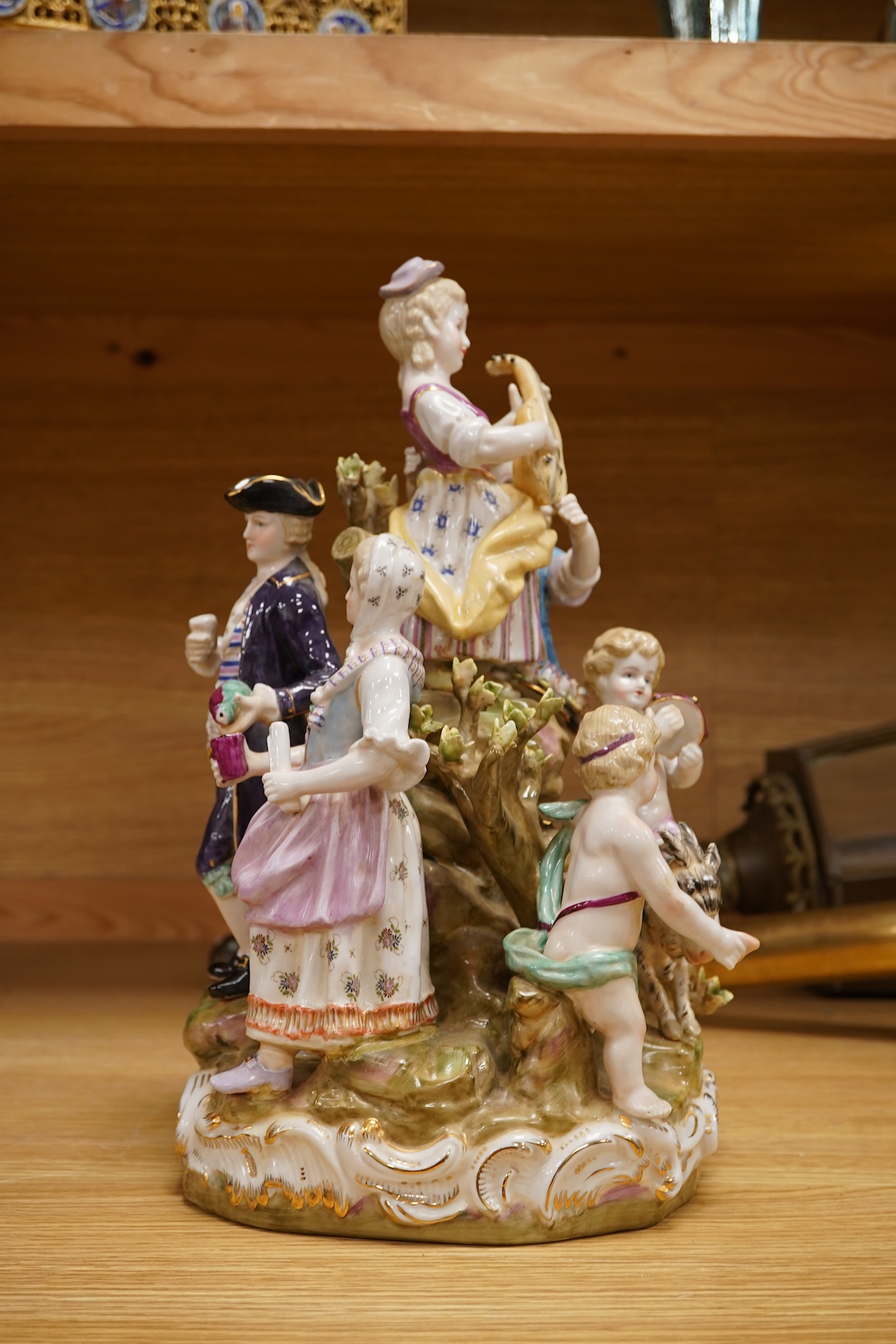 A large German porcelain group, figures playing instruments, 35cm high